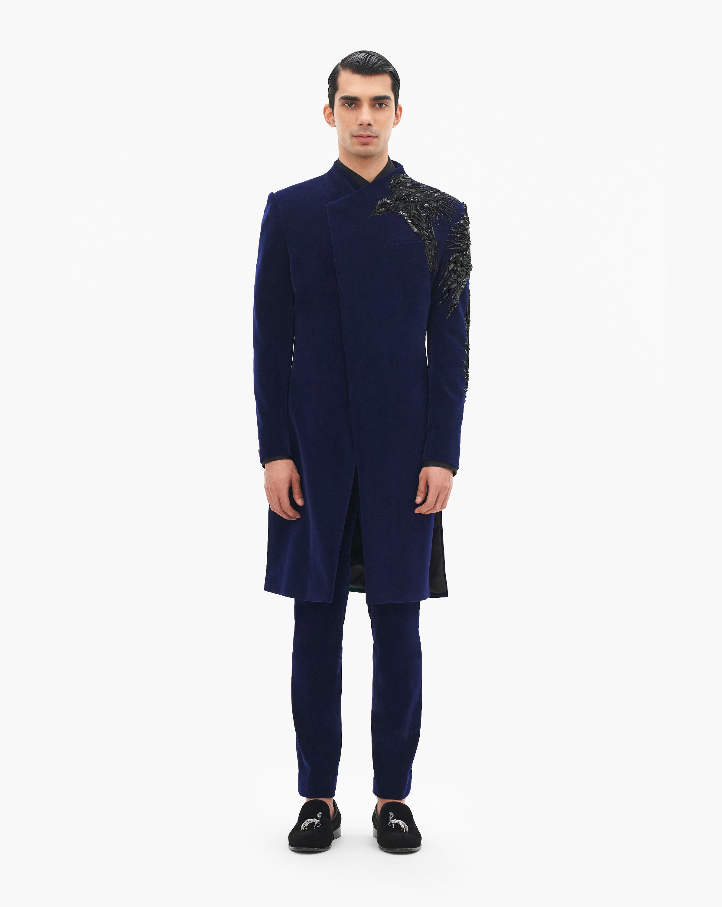 Model wearing blue suit with golden embroidery on it by Gaurav Gupta