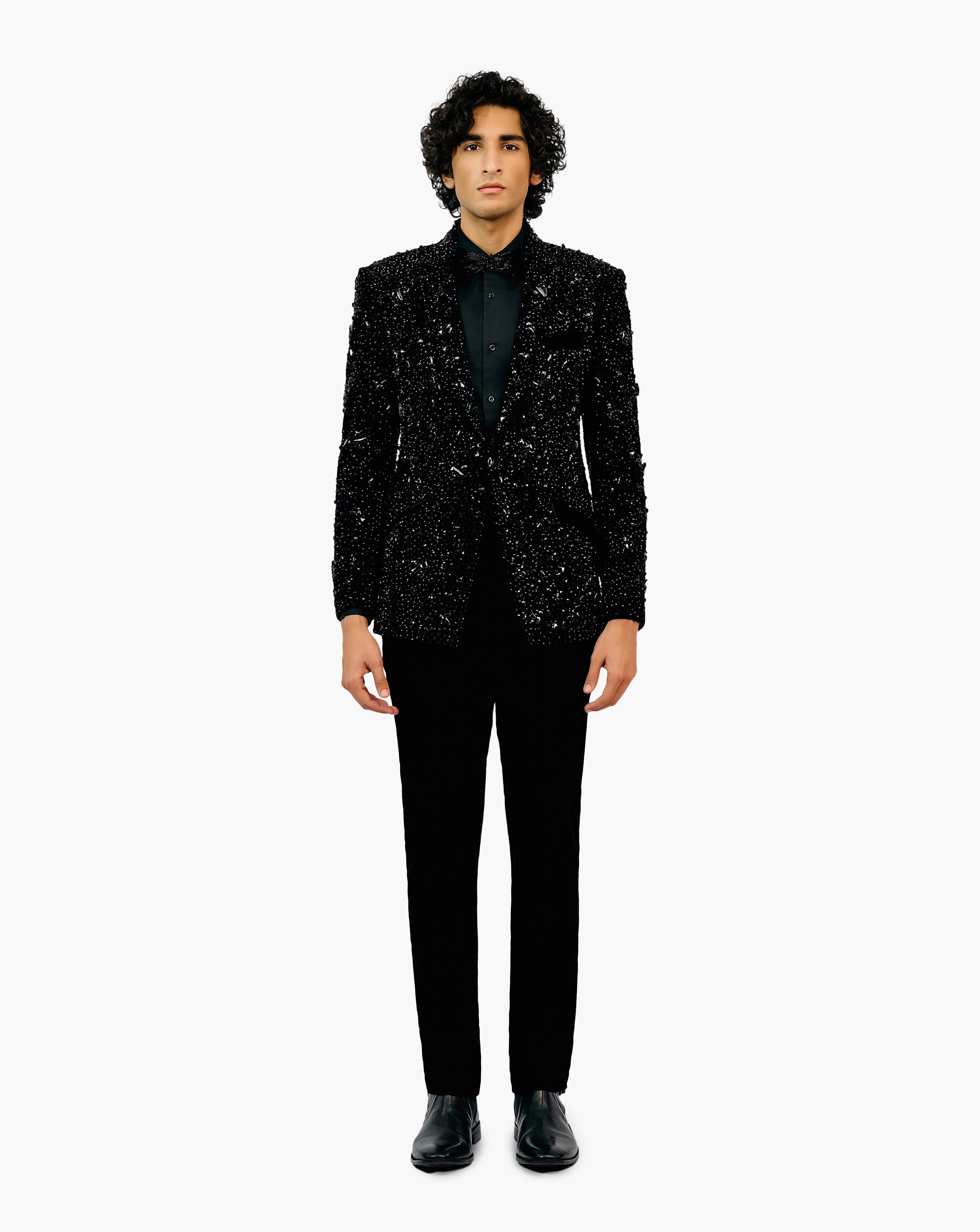 Man in a black glittery patterned suit set by Gaurav Gupta
