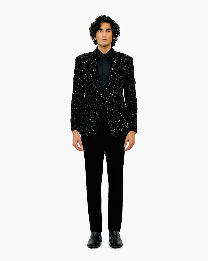 Man in a black glittery patterned suit set by Gaurav Gupta
