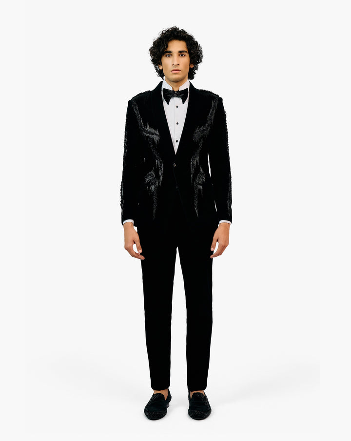 Man wearing a black tuxedo with a white shirt and black bow tie by Gaurav Gupta
