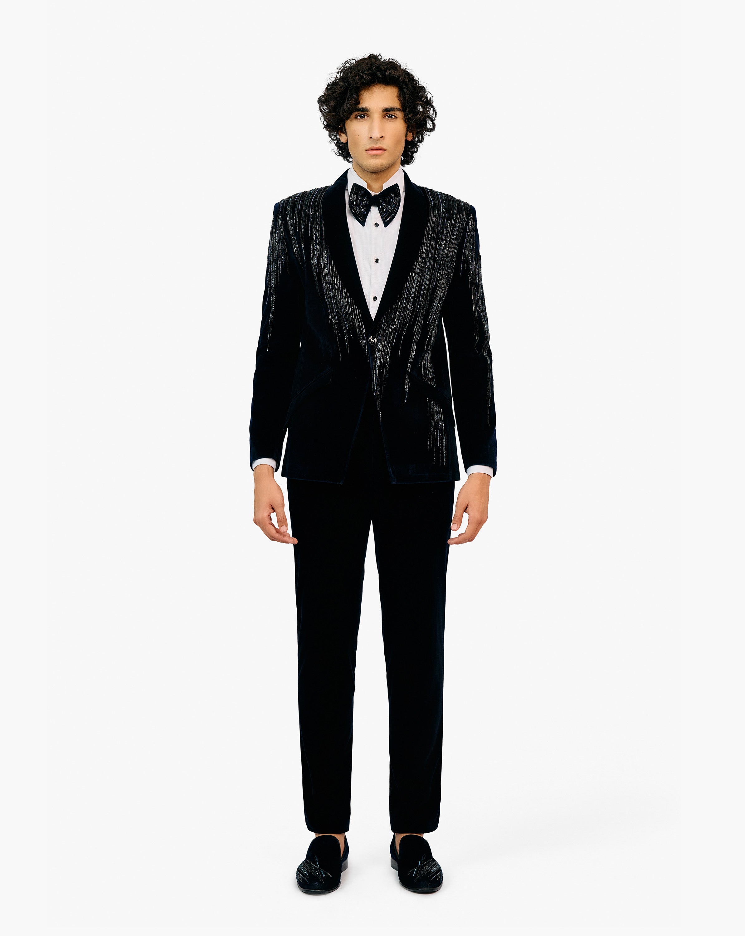Man in a black tuxedo with bow tie by Gaurav Gupta
