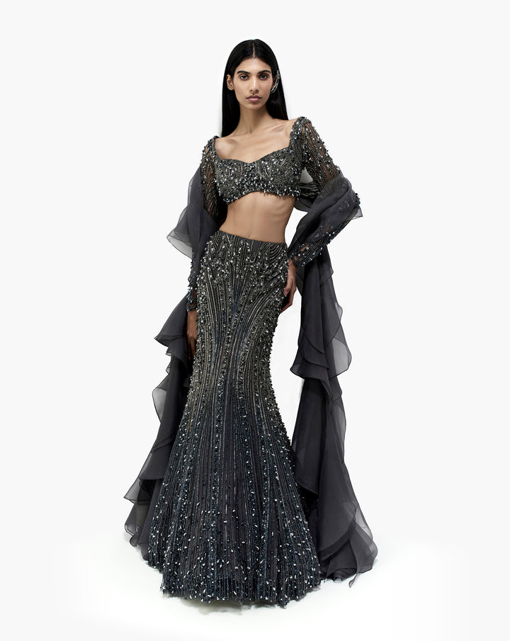 Woman wearing silver embroidered dress by Gaurav Gupta