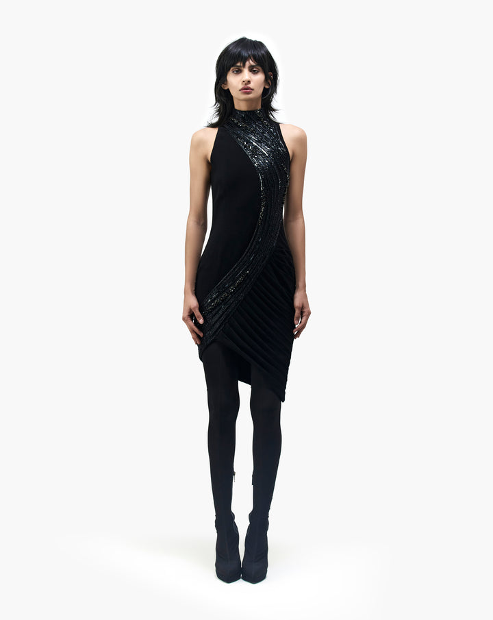 Model wearing a sleeveless black dress with shiny diagonal design by Gaurav Gupa