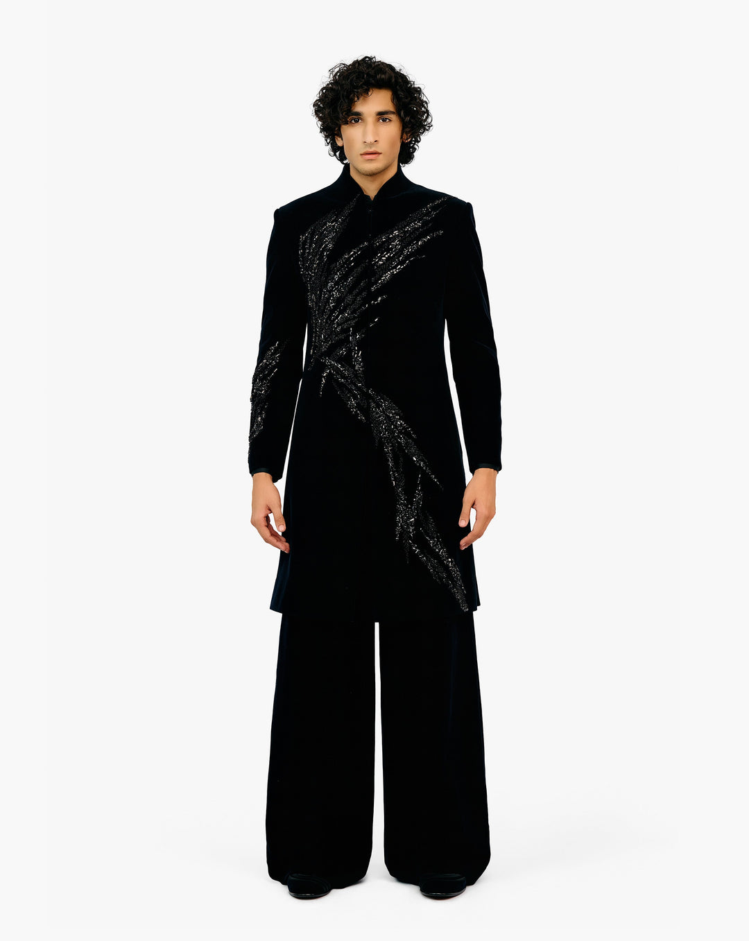 Man wearing black coat with silver embroidery on it with black pant by Gaurav Gupta