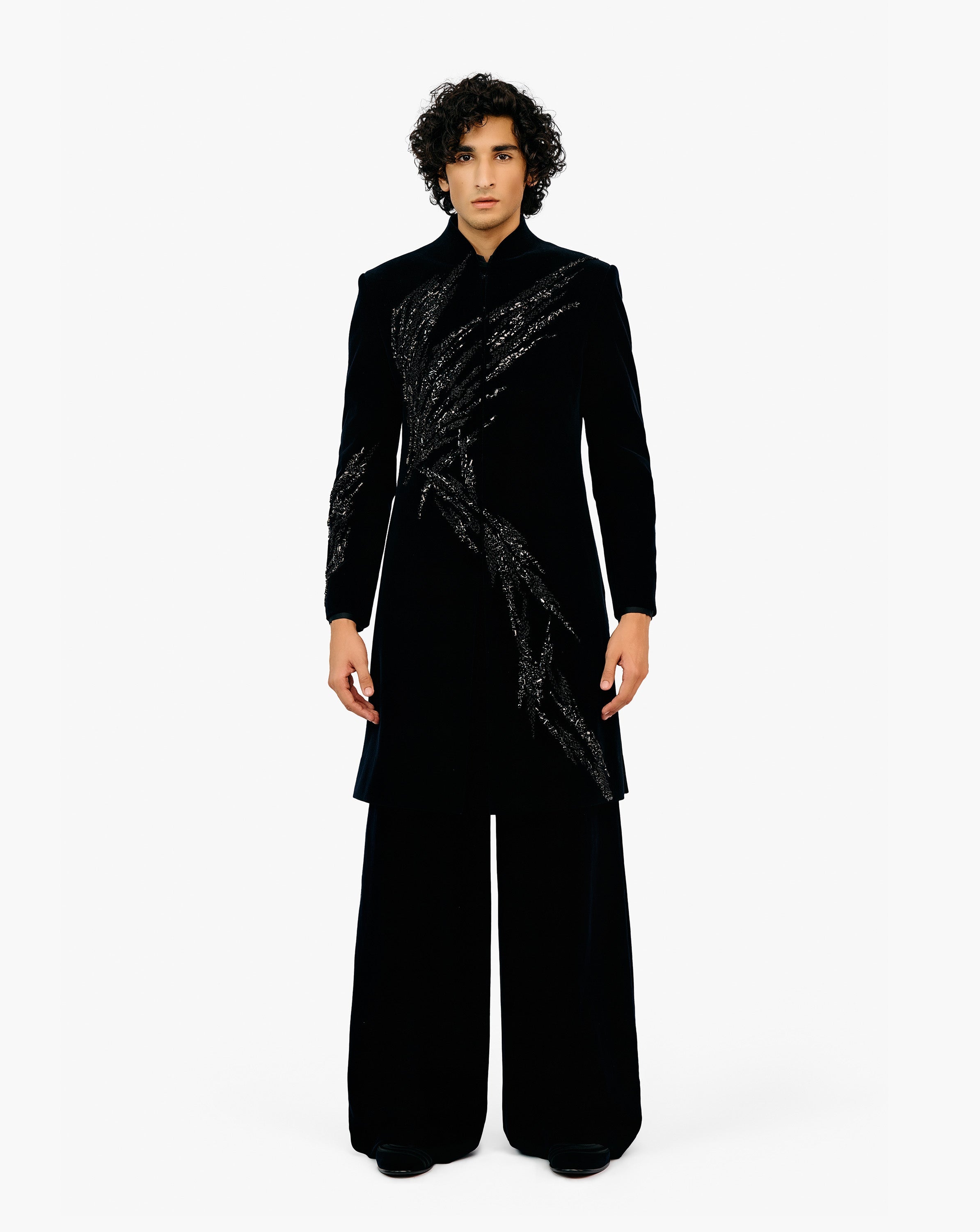 Man wearing black coat with silver embroidery on it with black pant by Gaurav Gupta