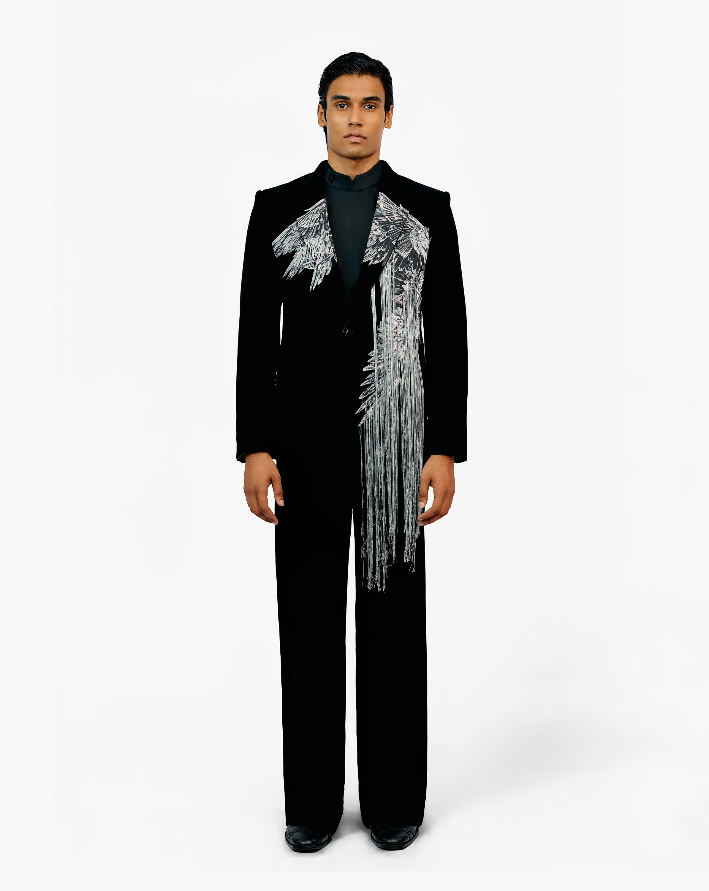 Model wearing black suit with silver design on it by Gaurav Gupta