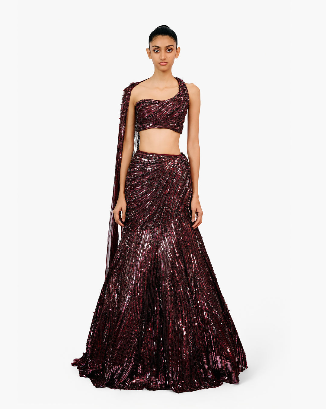 Woman wearing a dark purple embroidered dress by Gaurav Gupta