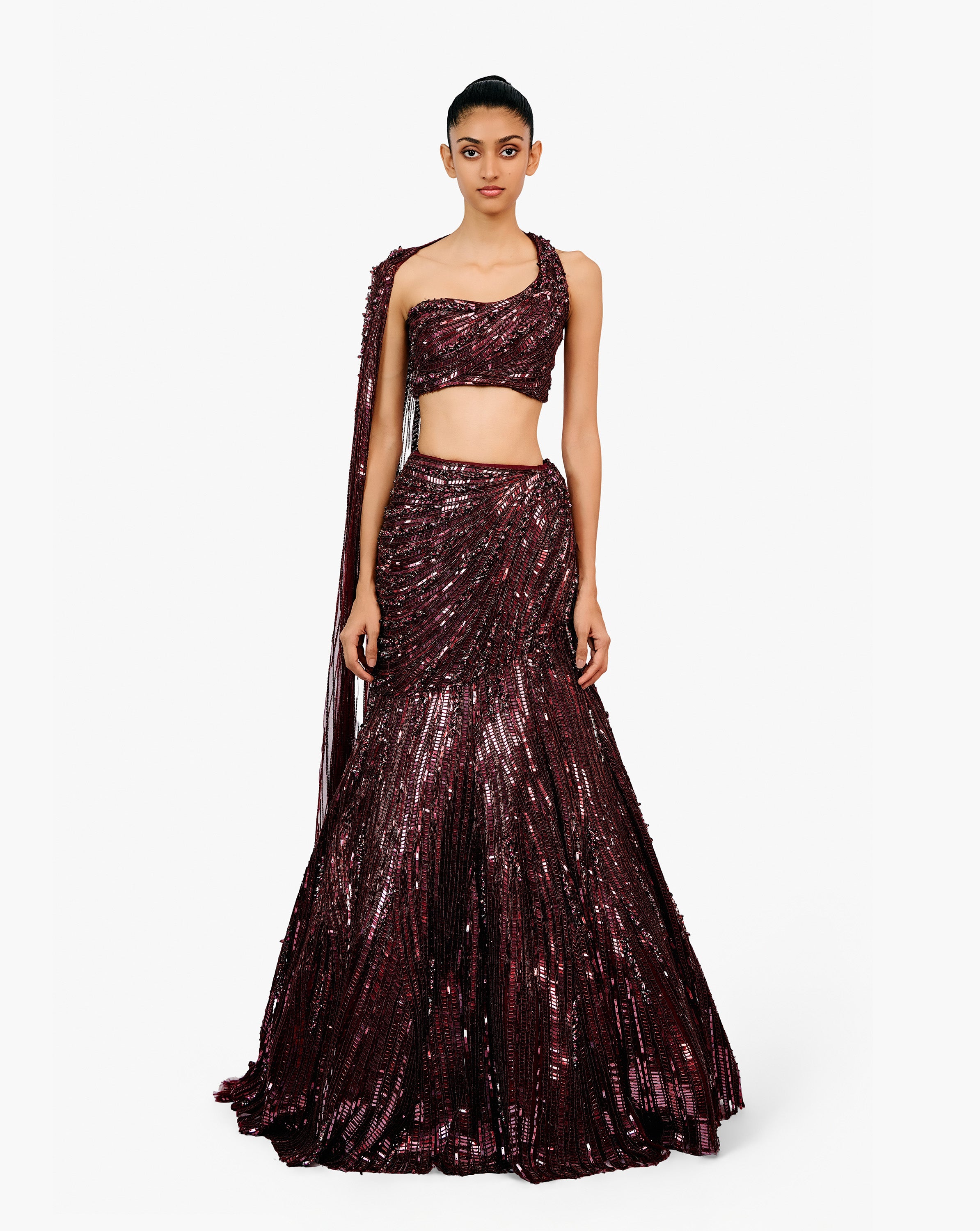 Woman wearing a dark purple embroidered dress by Gaurav Gupta